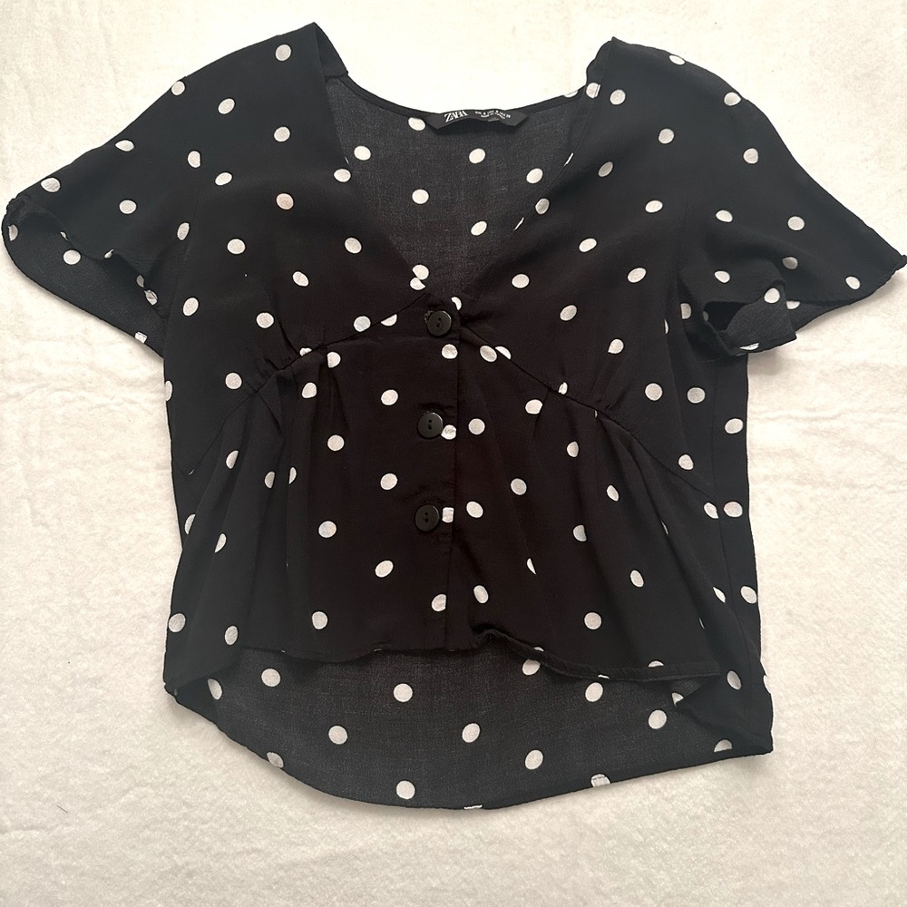 Button-up black and white polka dot blouse.